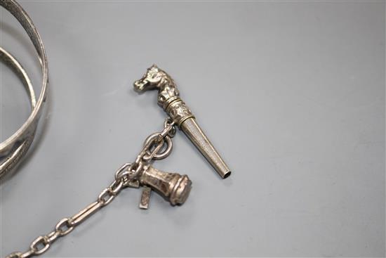 A modern silver and niello serpent bangle and a white metal tassle bracelet hung with four assorted charms, gross weight 65 grams.